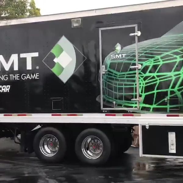 SMT broadcast truck with a green and black wrap